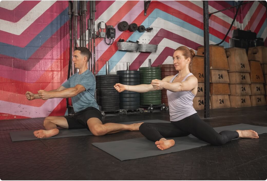 Women and man performing 90-90 hip stretch to fix their hip pain